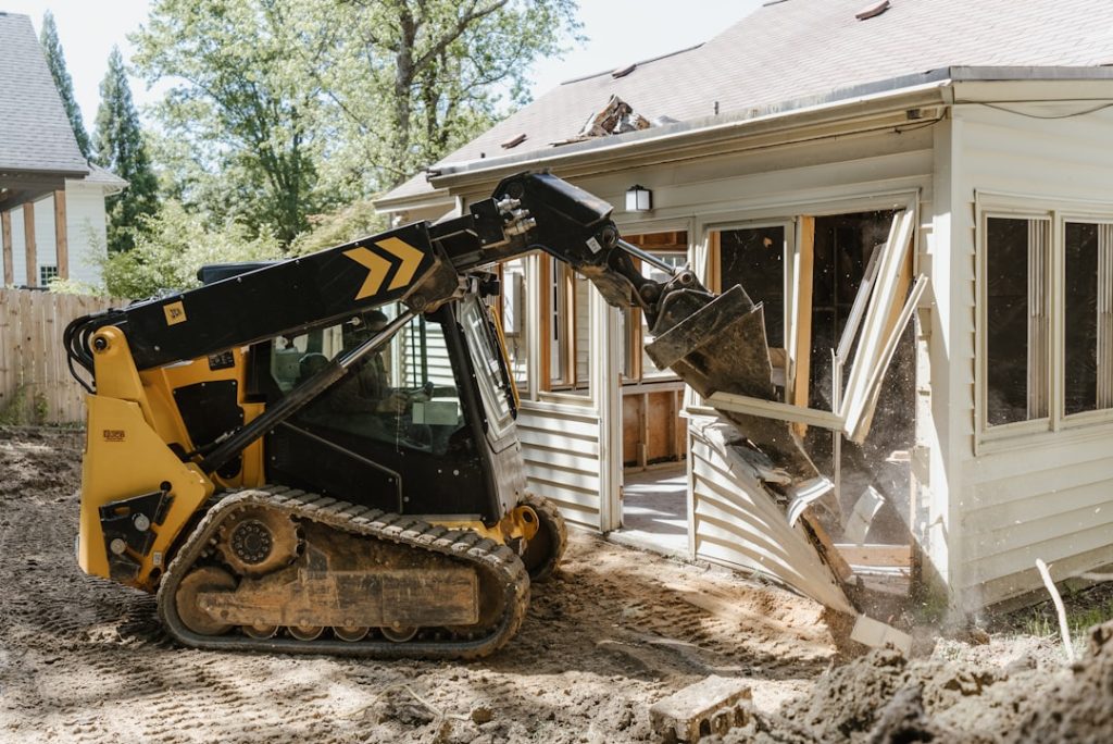 a bulldozer digging dirt in front of a house 8wlxgdoaxsm a bulldozer digging dirt in front of a house 8wlxgdoaxsm